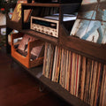 A Close up of the Irving Turntable station in dark walnut showing the amp cubby with a vintage marantz amp